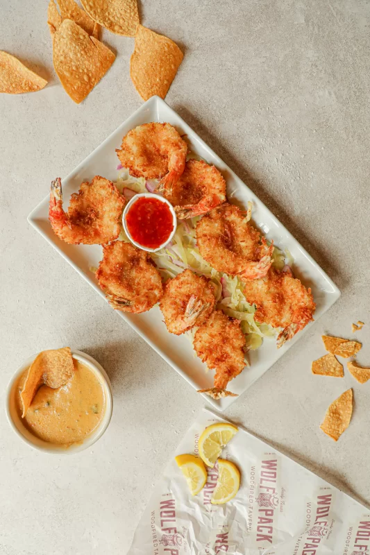 Crispy fried shrimp basket with French fries and coleslaw served at Wolfpack Woodfired Tavern in Sealy, Texas
