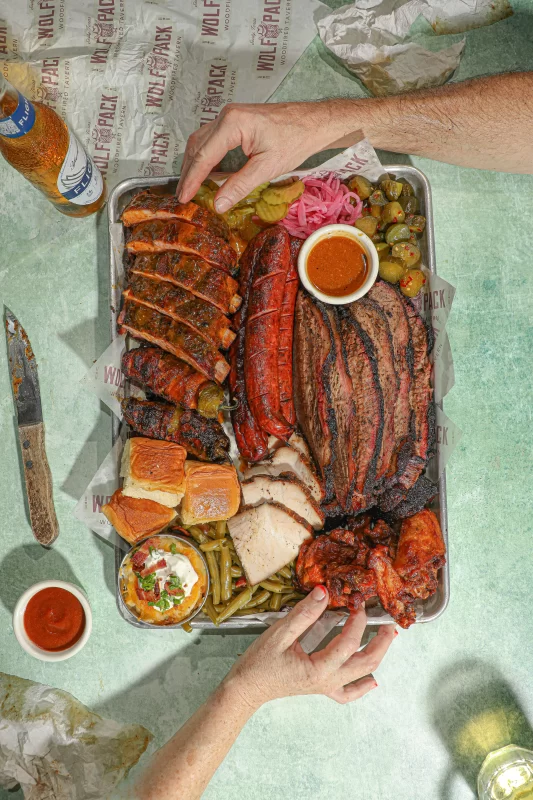 Premium prime brisket with perfect smoke ring and tender texture at Wolfpack Woodfired Tavern in Sealy, Texas